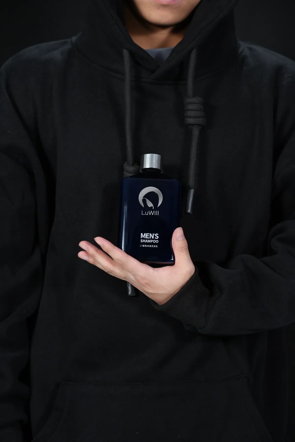 LuWill men's shampoo held against a black garment